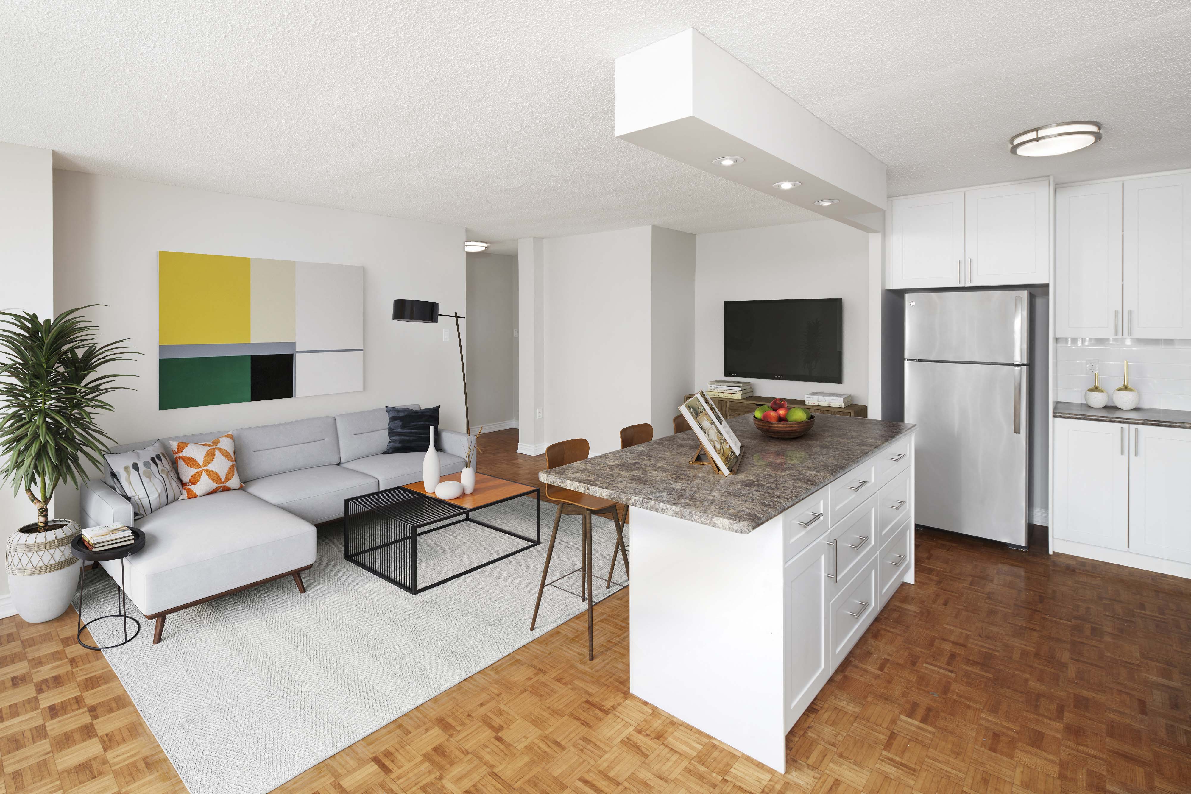 a living room with a couch and a kitchen